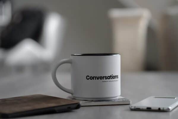 A coffee cup marked 'conversations'